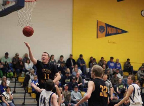 photo credit Kim Bodemann Junior Shawn Mahorney (dark jersey #11) goes up over Kason Brown to score on a lay up in the Mustang victory of the Wildcats.