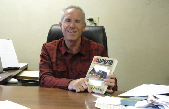 photo by Mister V Patrick Brower with his book, Killdozer.