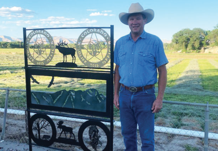 Bob Thompson stands in front of a piece of yard art given to him by his family for Father’s Day a few years ago. Seems a great thing to have in a picture for retirement.