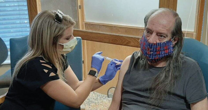 Kayla Boyd, Director of Quality, Risk and Infection Prevention at Middle Park Health, administers the first dose of Moderna vaccine to a Cliffview Assisted Living Center resident.