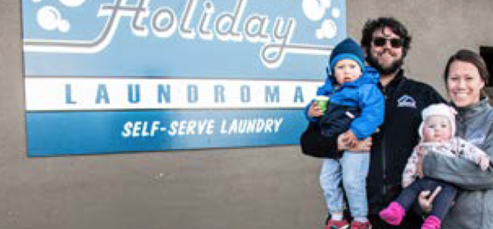 photo by Kim Cameron | Tyson Horner, the new manager of the Holiday Laundromat, poses with his wife, Chelsea, two-year-old son Jackson and five-month-old daughter Taylin. The Horners moved to Kremmling four years ago. photo by Kim Cameron | Tyson Horner, the new manager of the Holiday Laundromat, poses with his wife, Chelsea, two-year-old son Jackson and five-month-old daughter Taylin. The Horners moved to Kremmling four years ago.