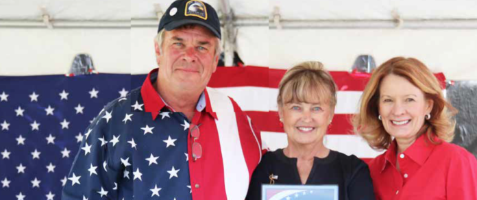Constitution Week organizer, Tom Goodfellow, Grand County Coroner Brenda Bock, and 56 KLZ Radio Host Kim Monson pose after Coroner Bock receives the American Patriot Award. She was recognized for her commitment to correcting reporting errors with COVID deaths.